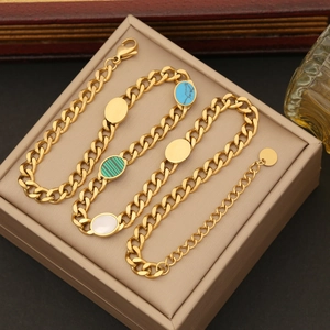 Detail of gold Cuban link bracelet with turquoise, malachite, and shell insets in jewelry box