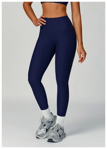 Detail of dark blue ribbed yoga pants with high waist and breathable compression fabric