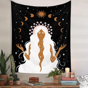 Detail of bohemian tapestry featuring moon phases and sun patterns on a black background