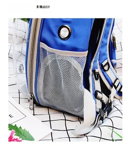 Detailed side view of pet backpack with mesh pocket, air holes and blue fabric texture