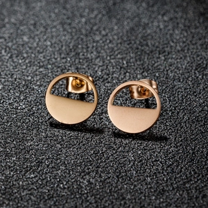 Minimalist geometric round earrings in gold finish with hollow circle design on gray background