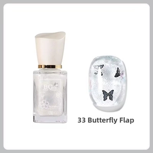 Close-up of milky white glitter nail polish with elegant butterfly nail art stickers