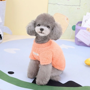 Detail of bright orange cloud fleece pet vest with soft texture and HELLO BABY patch