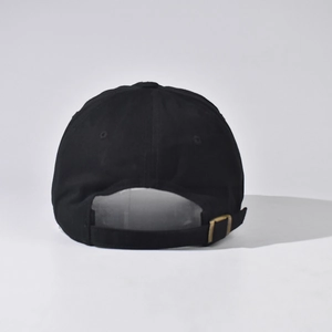 Detail view of cotton baseball cap with adjustable metal buckle and twill texture
