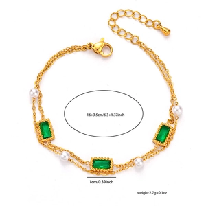 Detailed view of dual-layer gold-plated bracelet with emerald-cut green gems and pearls