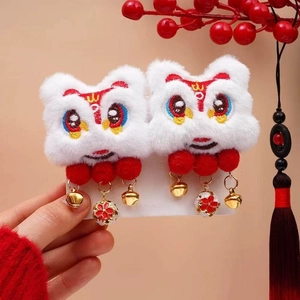 Detail of plush lion dance hair clips with red tassels and golden bells for New Year