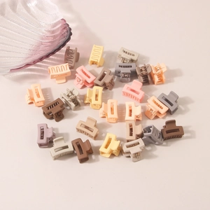 Detailed macro view of matte mini hair clips in Morandi colors for women's styling