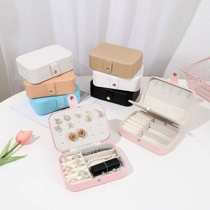 Multiple views of compact jewelry boxes showing ring slots and necklace hooks
