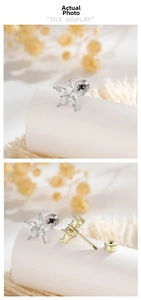 Detailed view of gold and silver star earrings with cubic zirconia and screw back