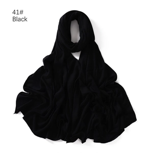 Detail of soft black jersey cotton hijab scarf showing texture on white background