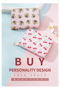 Close-up of pink PU leather card wallets with cute bee and cherry patterns and zippers