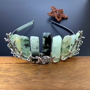 Detail view of silver branch tiara with green raw crystals and celestial moon icons