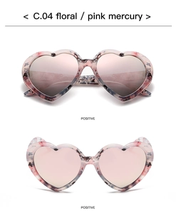 Detail view of pink floral heart-shaped sunglasses with pink mercury lenses and marble texture