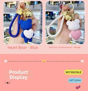 Detail of blue and pink resin heart bear keychain with woven lanyard and golden clasp