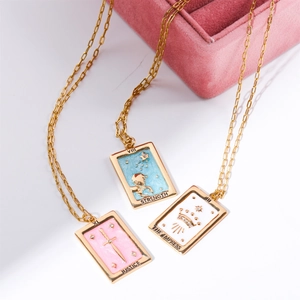 Three vintage tarot card necklaces in gold finish with blue, pink, and white enamel pendants