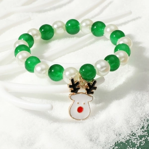 Christmas beaded bracelet with green pearls and a reindeer charm on snow background