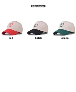 Detailed color display of cotton baseball caps with heart print in red, black and green