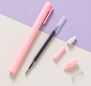 Disassembled view of pink macaron gel pen showing spring, refill, and casing components