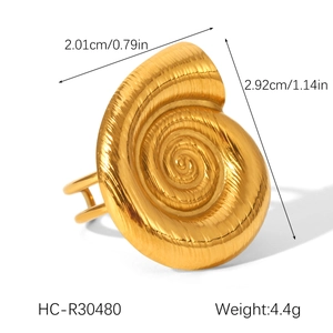 Detail view of golden seashell ring showing dimensions 2.92cm x 2.01cm and metallic texture