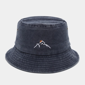 Close-up of vintage washed denim bucket hat with mountain sunset embroidery and air vents