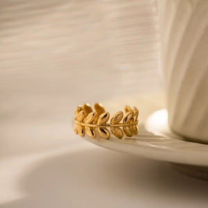Gold olive leaf branch open ring with textured hammer finish and polished surface