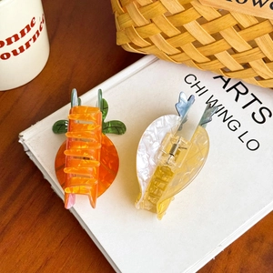 Cute carrot-shaped hair claw clips for women featuring vibrant colors and marble patterns