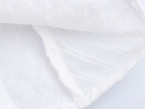 Macro shot of white mesh fabric texture and reinforced stitching on fly sleeves