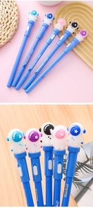 Close-up of creative astronaut pen caps and a colorful stationery set with LED lights