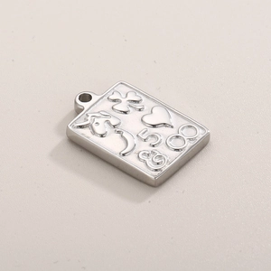 Detailed macro view of silver stainless steel rectangular charm with engraved symbols