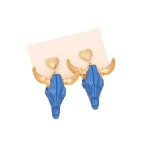 Bohemian bull skull earrings with gold heart studs on a minimalist display card