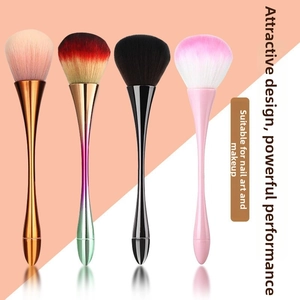 Macro shot of fluffy synthetic makeup and nail dust brushes with ergonomic metallic handles
