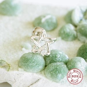 Macro shot of silver star stud earring with zircon and authentic S925 sterling silver stamp
