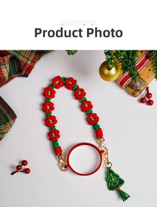 Detail of Christmas themed hand-woven water bottle strap with festive tree charm