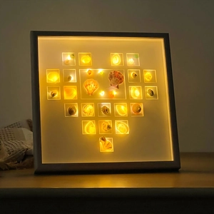 DIY shell heart shadow box frame with warm LED light for creative home tabletop decor