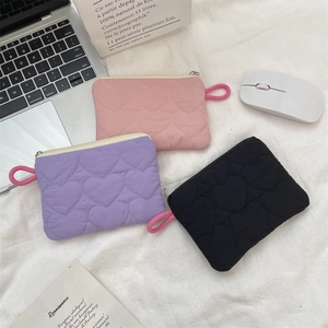 Quilted heart mini pouches in pink, purple, and black with zippers and lanyards