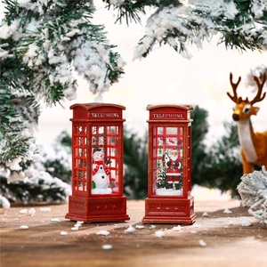 Close-up of lighted Christmas telephone booth lanterns with Santa and snowman figurines
