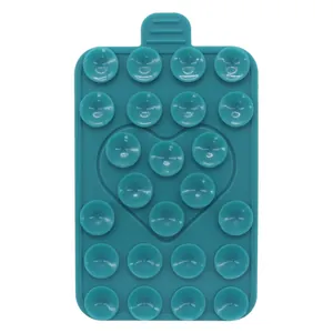 Macro view of a teal silicone heart suction cup phone holder showing 19 suction cups