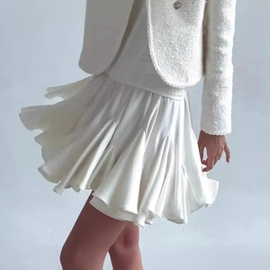 Tailleur chic en tweed blanc crème comprenant une veste courte et une jupe plissée