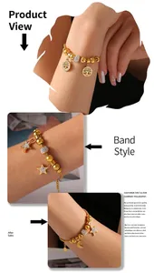 Detailed model shot of gold beaded charm bracelet with star moon and tree of life charms