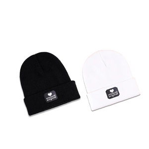 Winter knitted beanies in black and white with unusual original heart logo patches