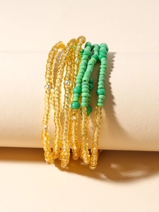 Detail of bohemian colorful seed bead waist chains in yellow and green tones