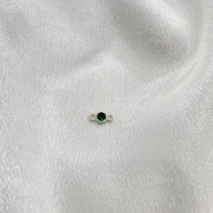 Detail of silver S925 connector with emerald green crystal for DIY jewelry making