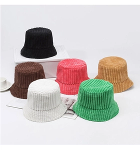 Multiple colors of corduroy bucket hats including black, pink, and green on white background