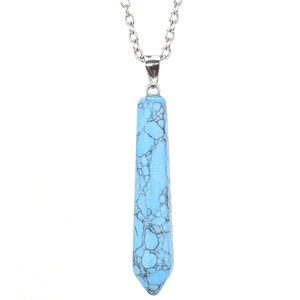 Macro shot of turquoise hexagonal point pendant with silver bail and delicate chain