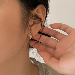 925 sterling silver hoop earrings with cubic zirconia worn by a model in a minimal style
