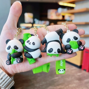 Close-up of four cute panda keychains holding bamboo with green Baby wrist straps