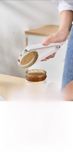 Close-up of multifunctional manual jar opener with non-slip serrated edge for easy grip