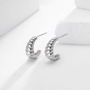 Detailed close-up showing S925 hallmark on minimalist silver croissant hoop earrings