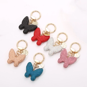 Sparkling crystal butterfly keychains in various colors with golden metal ring accents