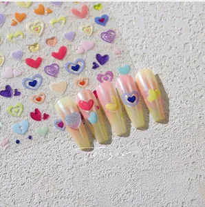 Detailed view of colorful heart-shaped nail stickers applied on almond-shaped nails